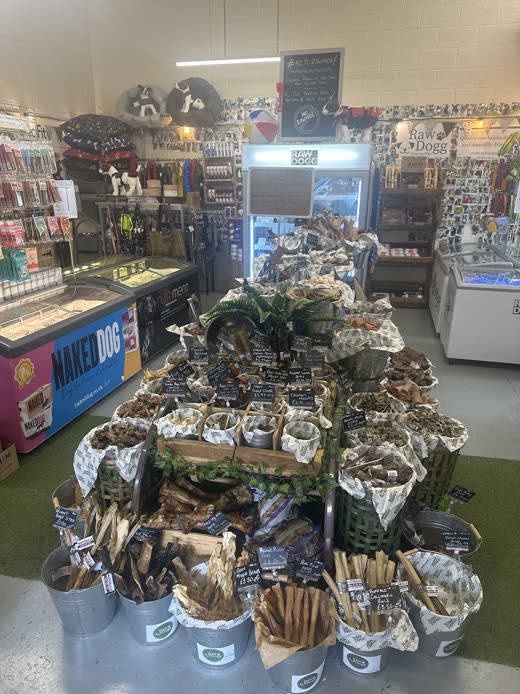 Central display of natural chews and treats inside the shop